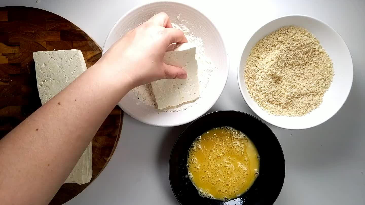 crumbs. I recommend using one hand for the dry ingredients and one hand in the egg. Then you won't end up breading your fingers as well! Repeat with all the pieces of tofu.