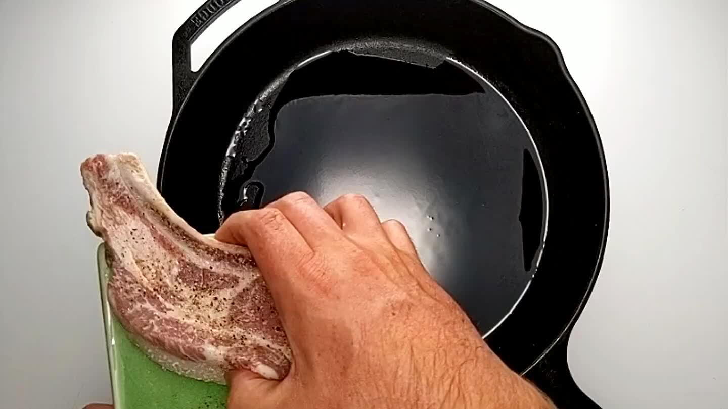 should be close to done at this point. I was lucky enough to get a thick, bone-in pork chop here. After searing, I tipped the chop over on its fat cap and put the whole heat-safe skillet in the oven at 400°F for about 15 minutes.