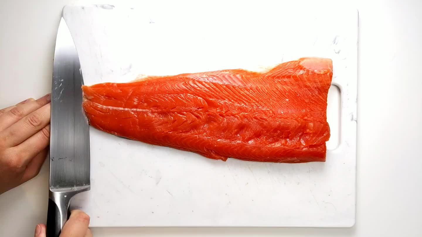 ef's knife between the salmon and the skin. Tilt the blade of the knife slightly downward as you move in a slight sawing motion. Firmly hold onto the skin (use a paper towel for more traction if you need) and pull gently in the opposite direction that you are slicing. The skin should come off in one piece, but if not, turn fillet over and remove any leftover skin.