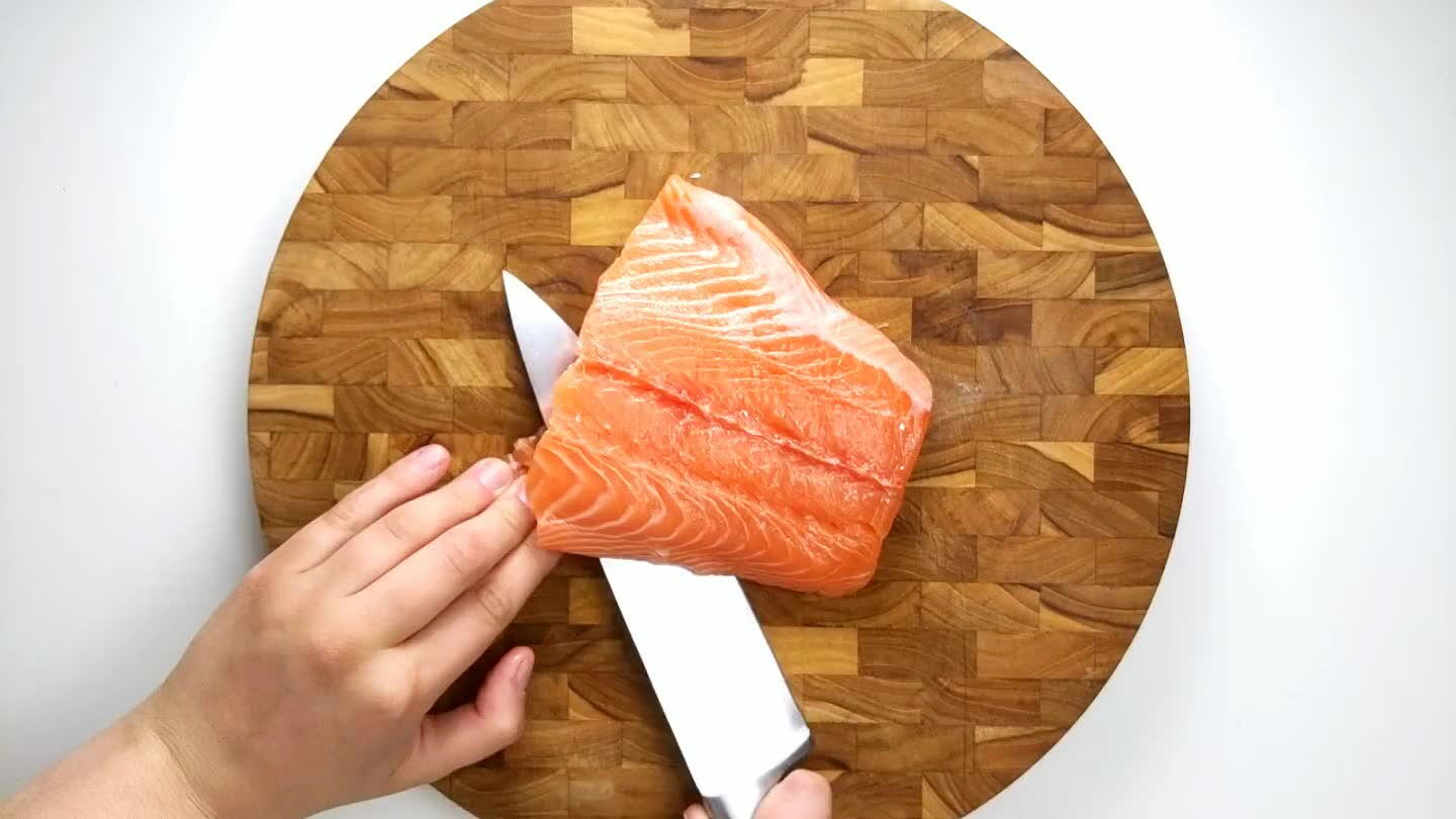 on and the skin. Tilt the blade of the knife slightly downward as you move in a slight sawing motion. Firmly hold onto the skin (use a paper towel for more traction if you need) and pull gently in the opposite direction that you are slicing. The skin should come off in one piece, but if not, turn fillet over and remove any leftover skin.