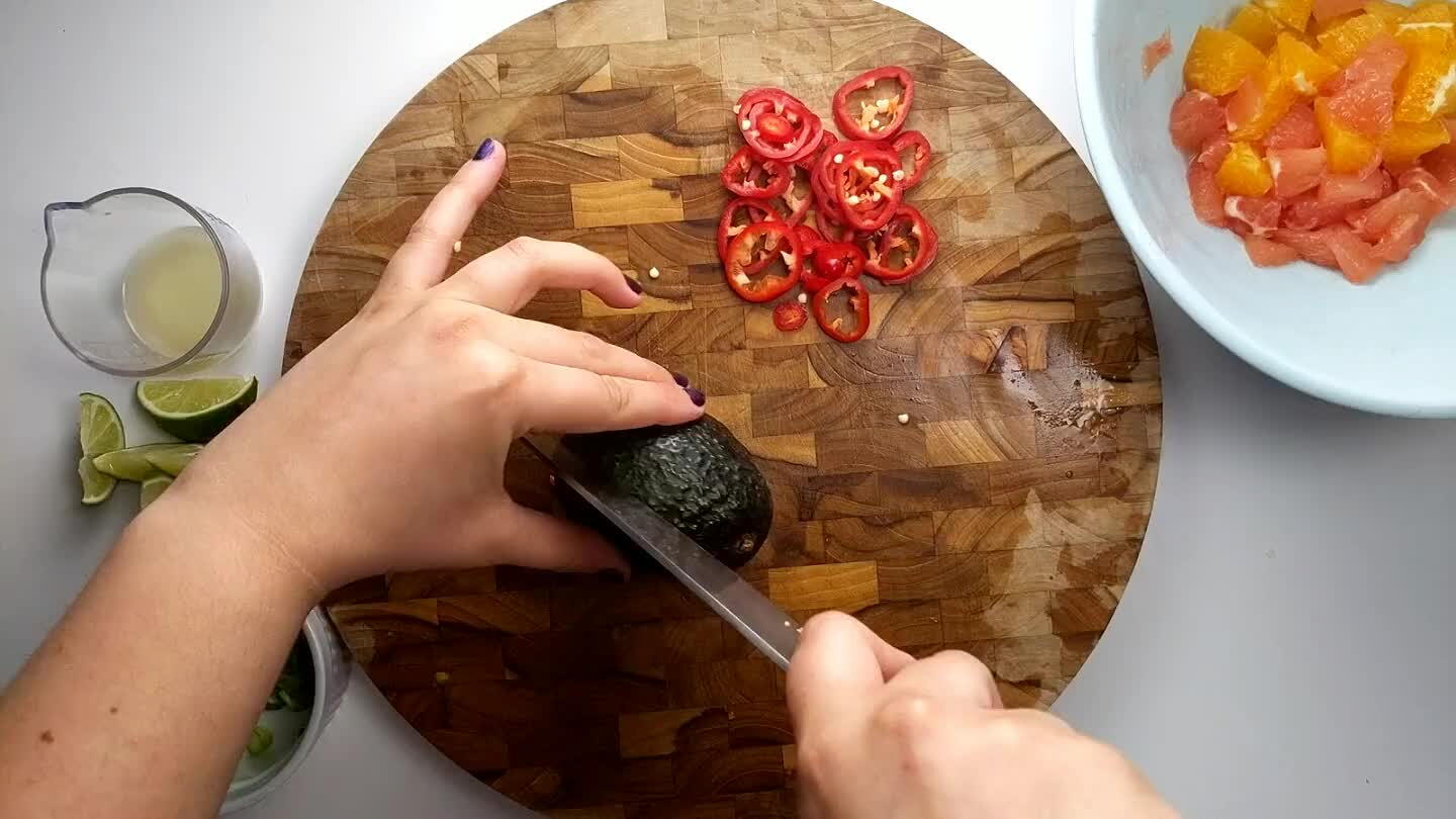 the knife to grip and twist the pit to remove it.