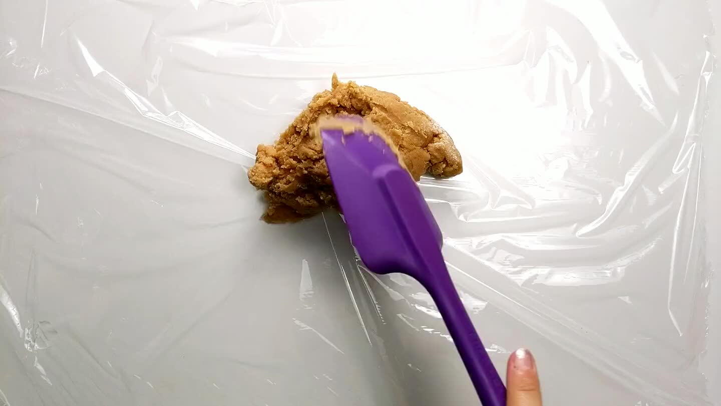the pan and fold the plastic into a square so that it fits into the pan. Press the dough to fit in the plastic square.