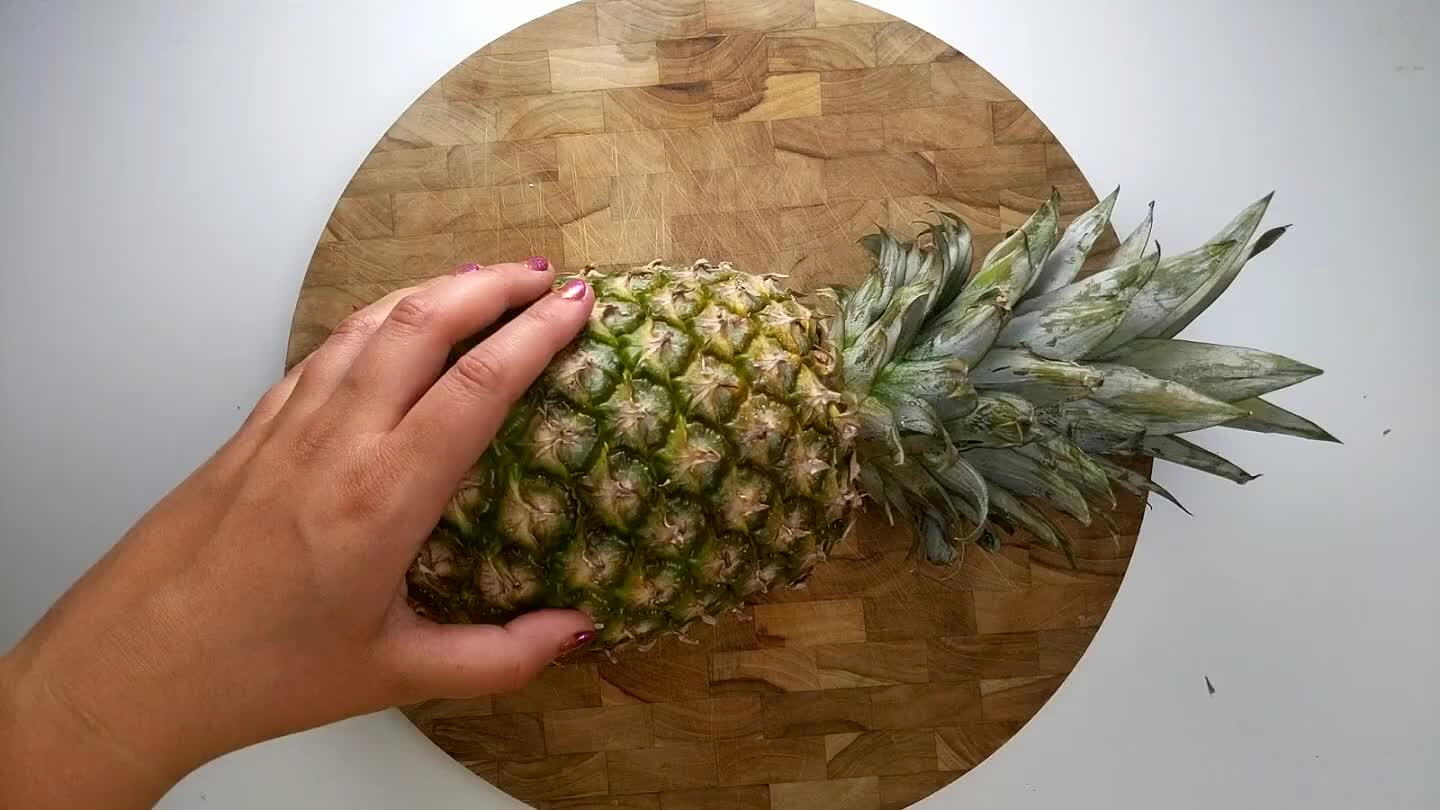 o remove strips of the skin. Once the skin is removed, cut the pineapple in quarters.