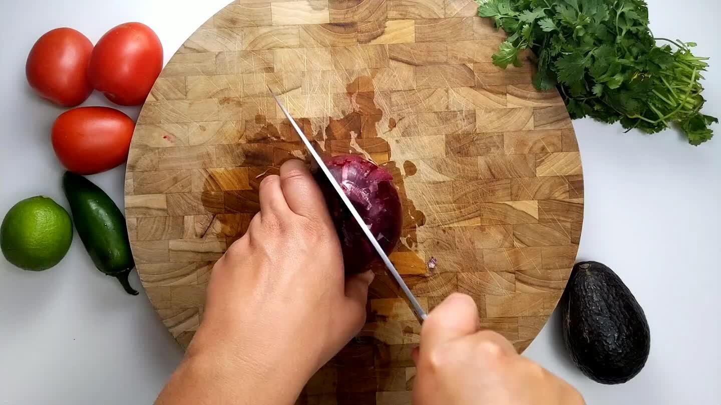 ff the stem side and remove the skin. Cut twice into the side of the onion with the knife parallel to the board.