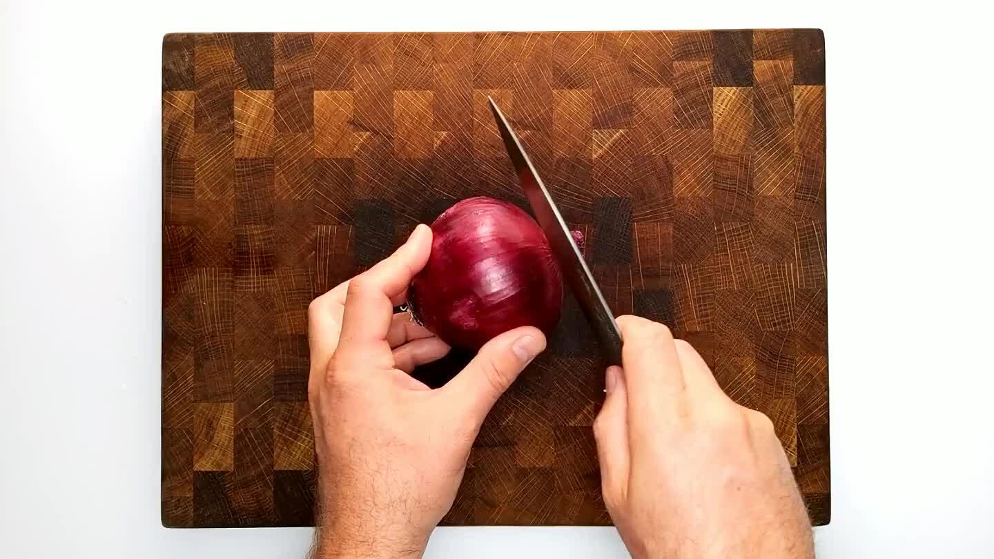 through the stem to root axis. Slice finely from the top, perpendicular to the sliced stem face without cutting through the root end. Then slice into the stem face several times with the blade parallel to the board to complete a hatch pattern. Slice again from the top perpendicular to the previous slice to dice finely.