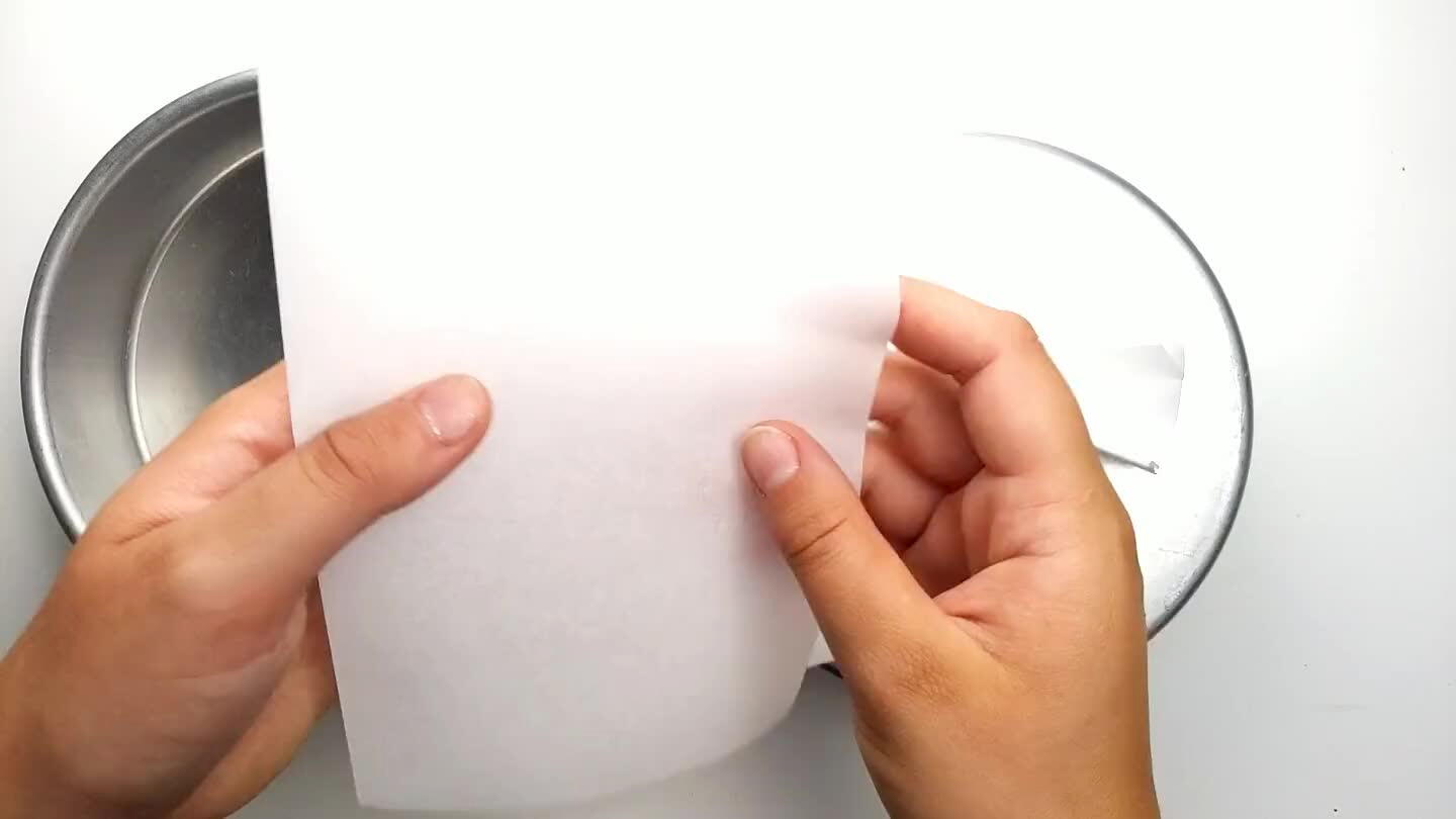 ayered cake. Fold a square of parchment paper into a triangle.