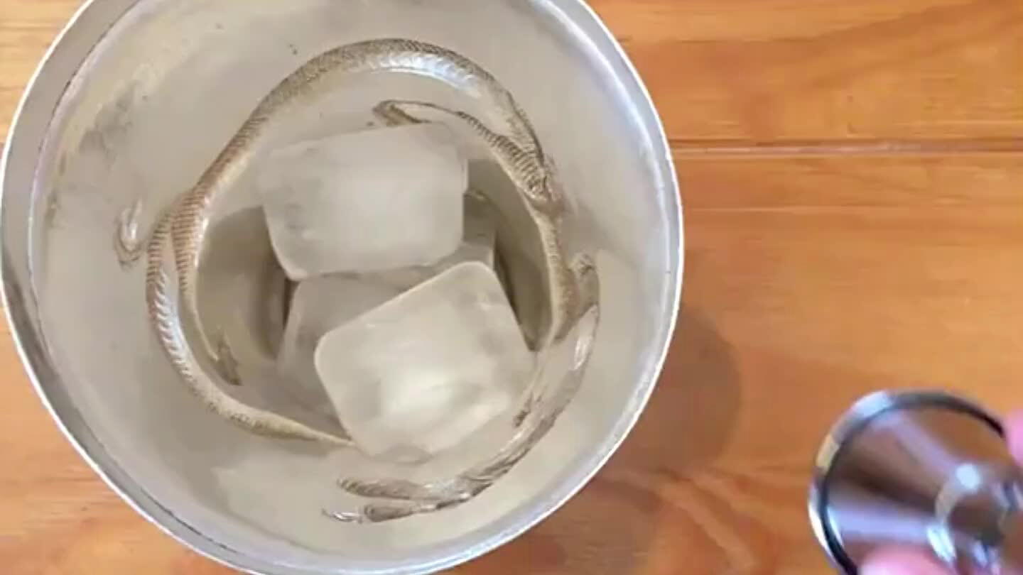 cocktail shaker. Squeeze the lime into the shaker.