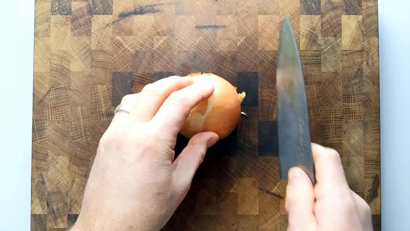 through the stem to root axis. Slice finely from the top, perpendicular to the sliced stem face without cutting through the root end. Then slice into the stem face several times with the blade parallel to the board to complete a hatch pattern. Slice again from the top perpendicular to the previous slice to dice finely.