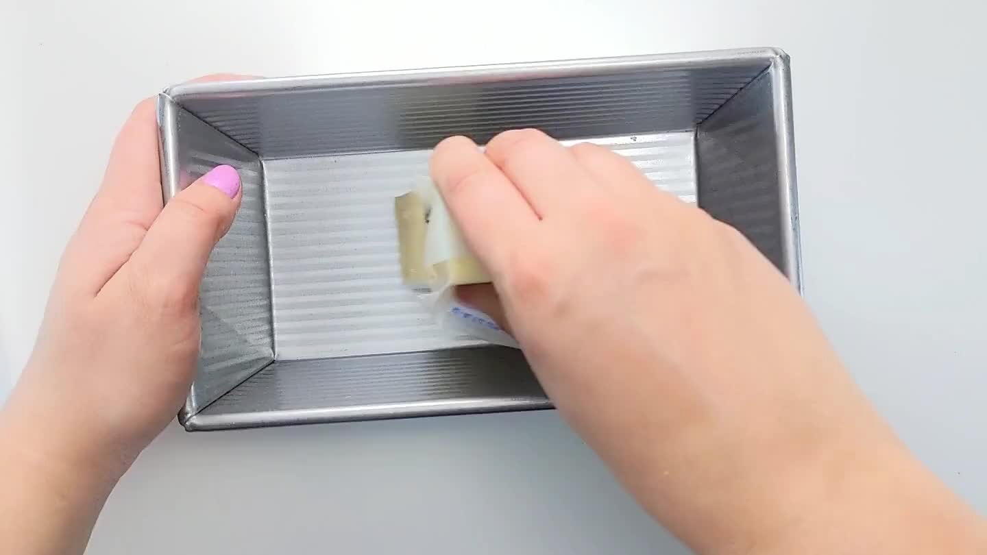 paper inside that hangs over the edges. Generously coat the pan with butter being sure to reach the corners.