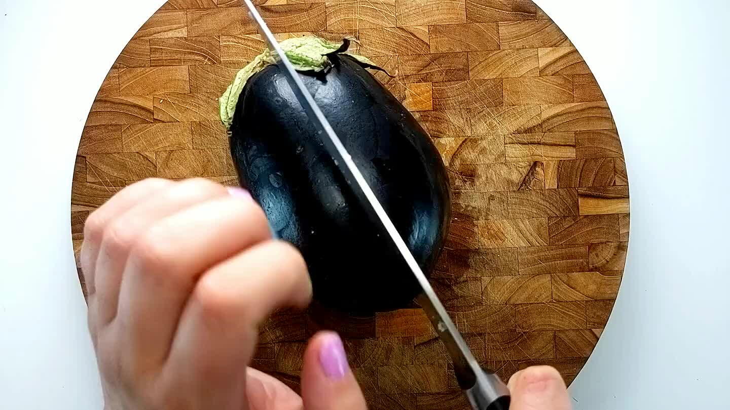 use a knife and slice as thin as possible. If your eggplant is quite wide, cut it in half before slicing.