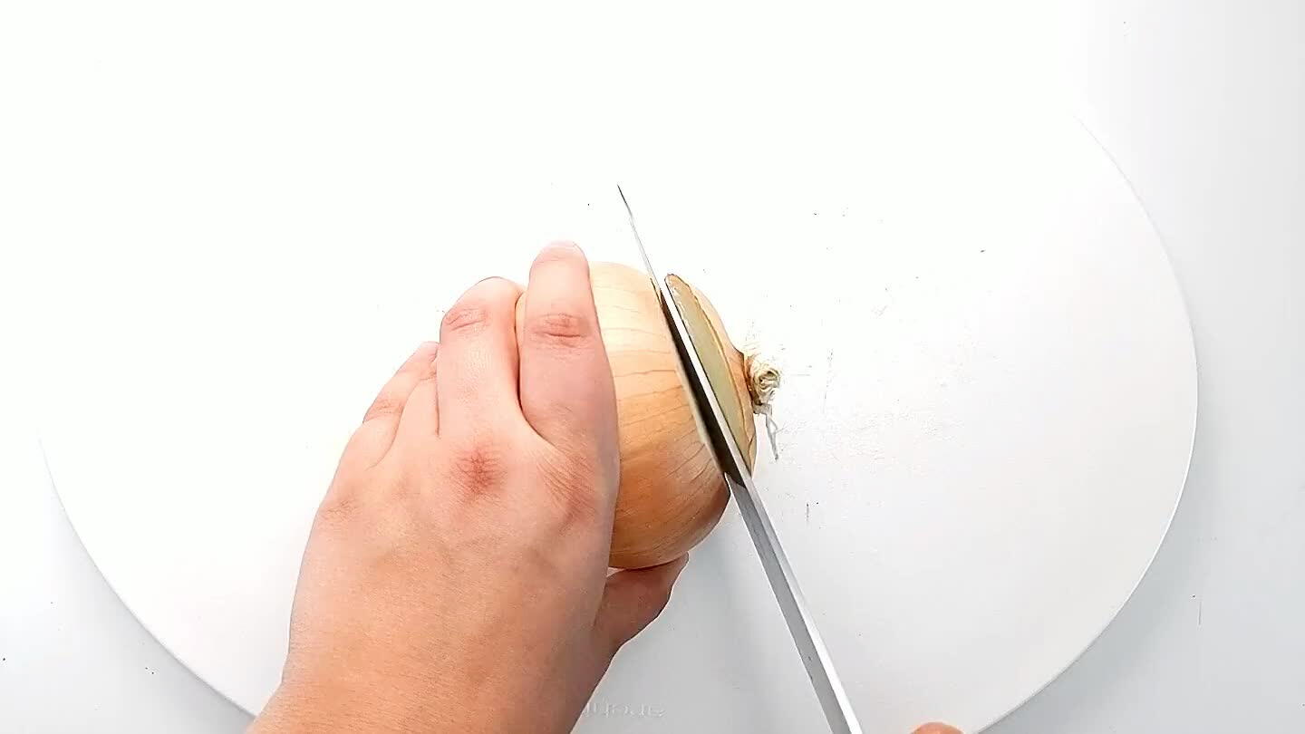 nto the onion with the knife parallel to the cutting board. Then slice into strips and dice.